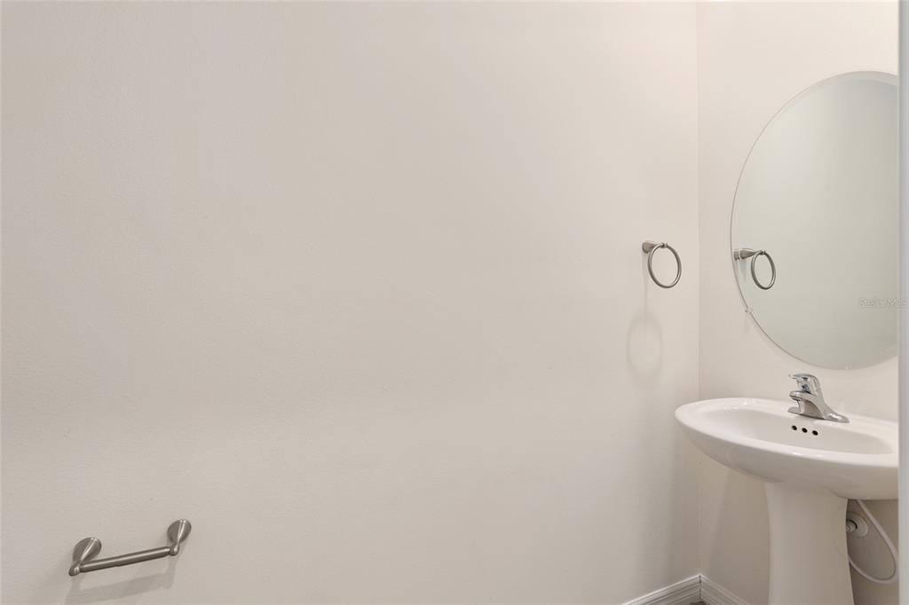 13818 Northwest 9th Road Newberry, FL 32669 - Photo 6 of 56 a bathroom with a sink and mirror