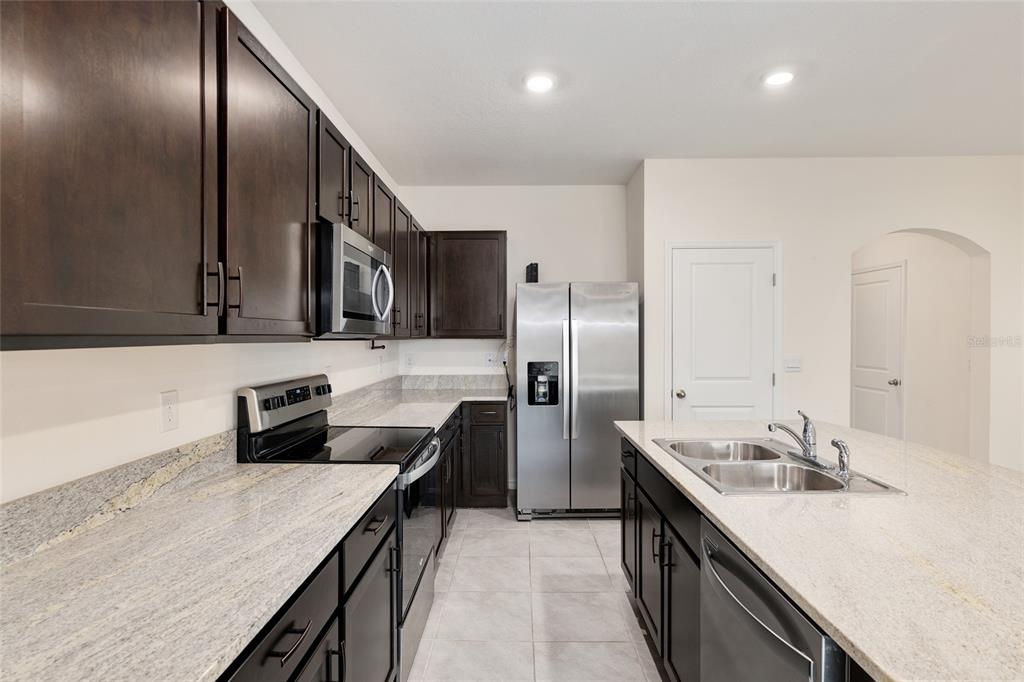 13818 Northwest 9th Road Newberry, FL 32669 - Photo 9 of 56 a kitchen with a sink and refrigerator
