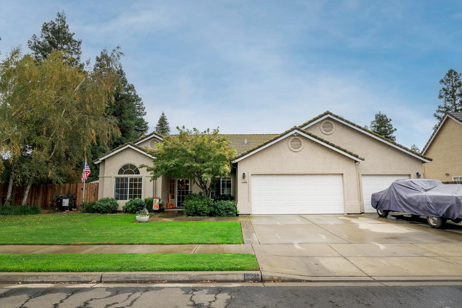 a front view of a house with a garden and garage
