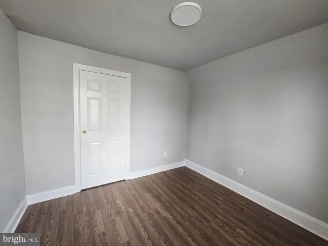 a view of an empty room and wooden floor