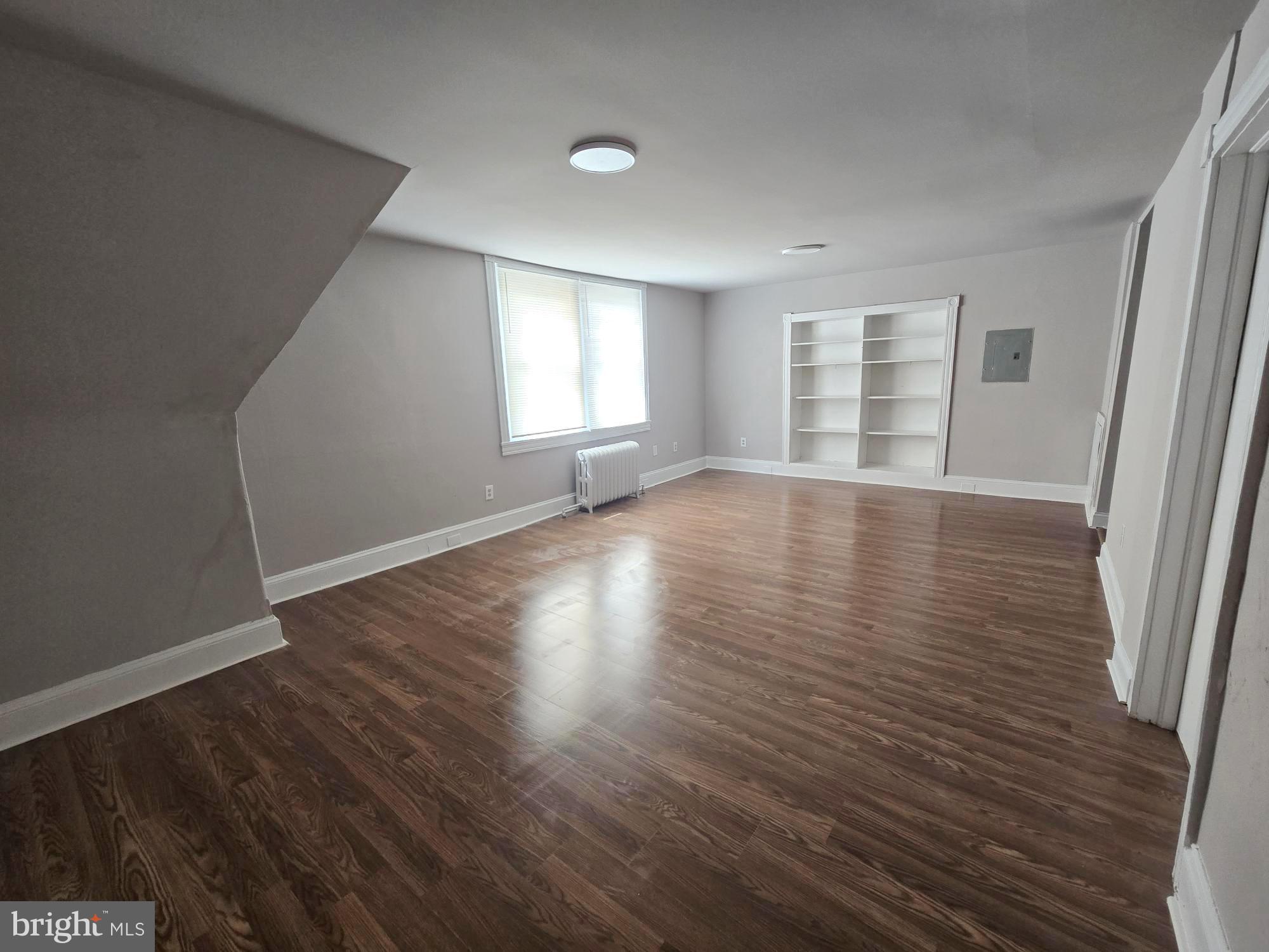 61 Owen Avenue Lansdowne, PA 19050 - Photo 4 of 19 an empty room with wooden floor and windows
