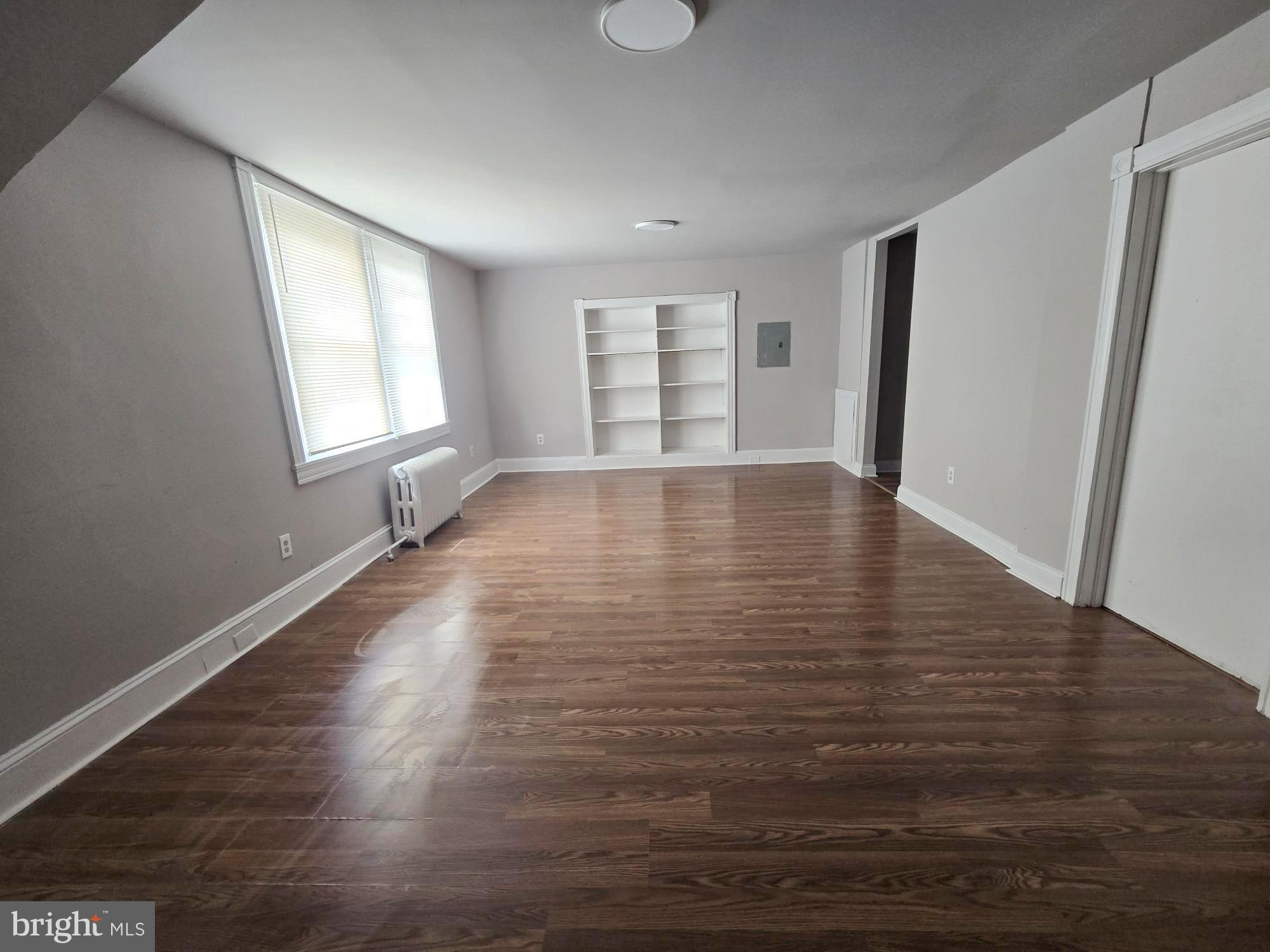 61 Owen Avenue Lansdowne, PA 19050 - Photo 5 of 19 a view of an empty room with wooden floor and a window