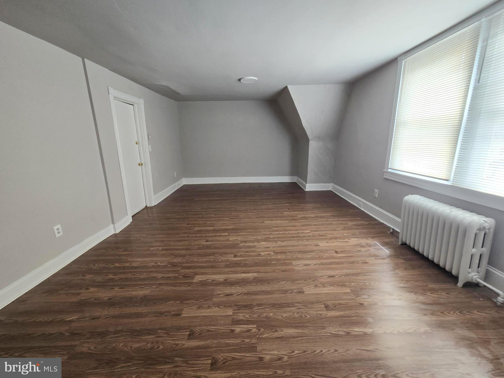 61 Owen Avenue Lansdowne, PA 19050 - Photo 6 of 19 a view of an empty room with wooden floor and a window