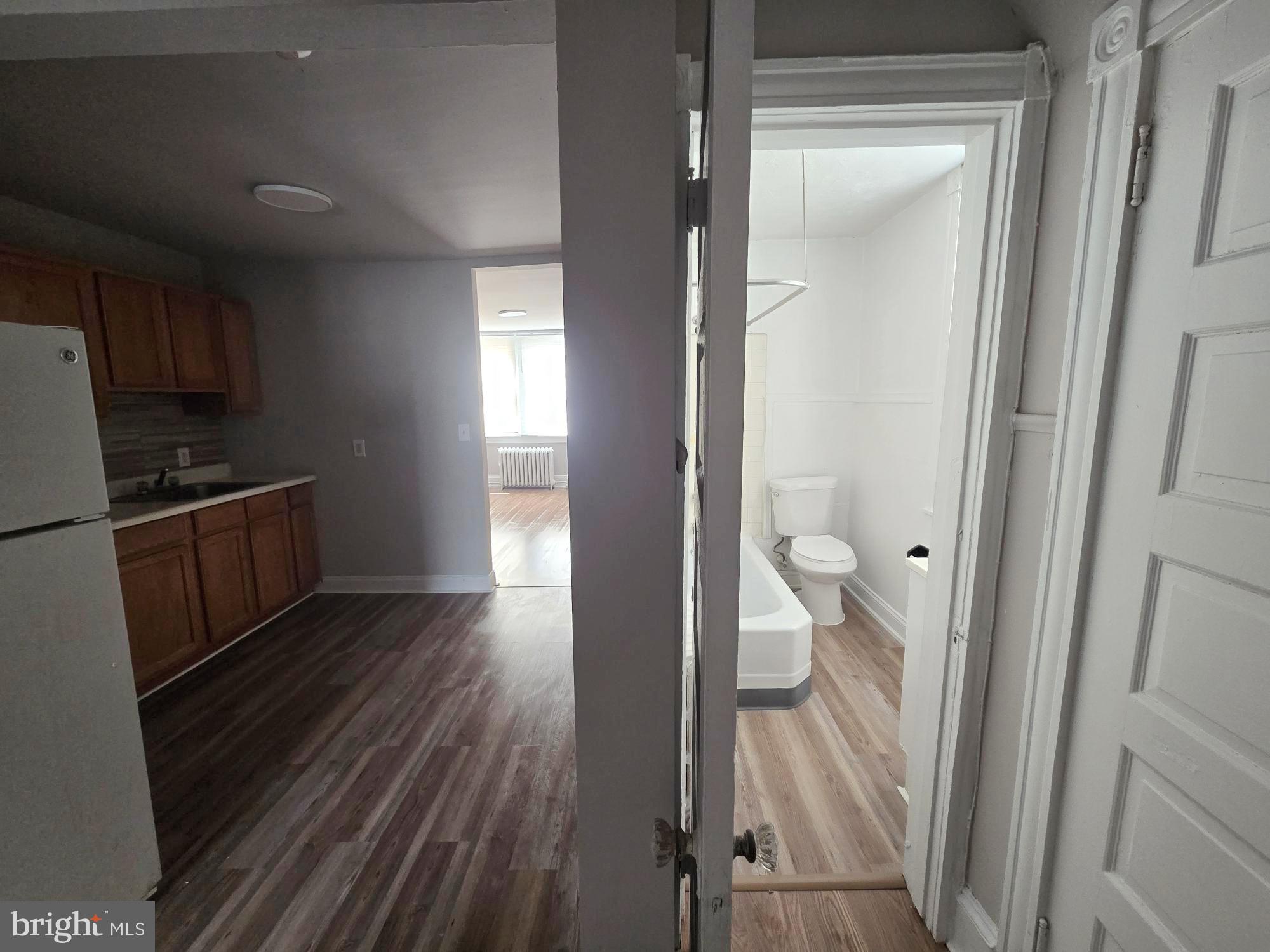 61 Owen Avenue Lansdowne, PA 19050 - Photo 10 of 19 a view of a kitchen from the hallway with a wooden floor