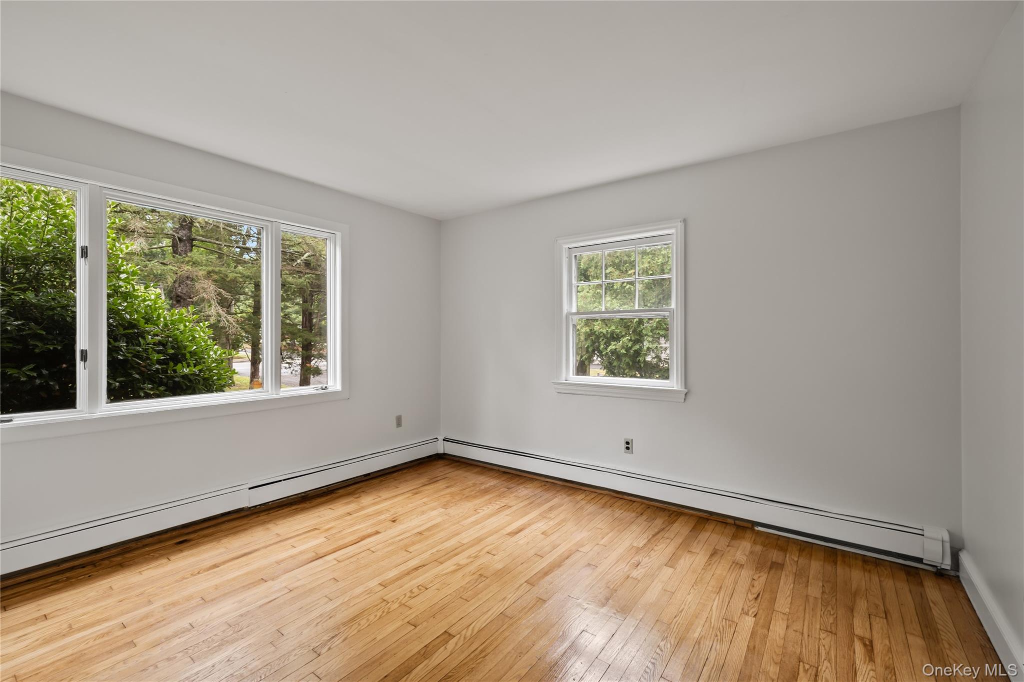 281-283 Old Haverstraw Road Congers, NY 10920 - Photo 12 of 41 a view of an empty room with wooden floor and a window