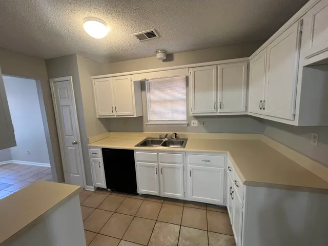 a bathroom with a double vanity sink toilet and mirror