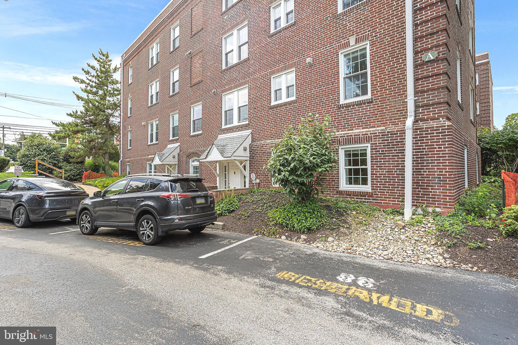 104 Woodside Road, Unit A103 Haverford, PA 19041 - Photo 2 of 2 a car parked in front of a brick building