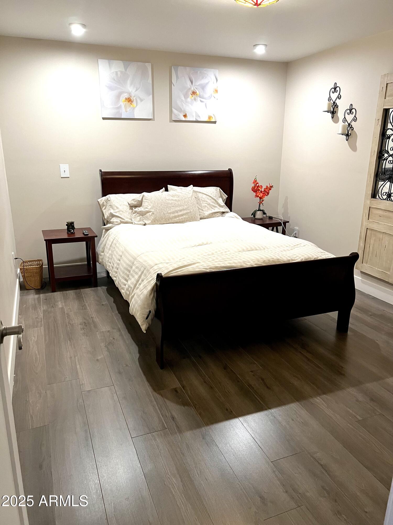 311 Solana Avenue Ajo, AZ 85321 - Photo 11 of 22 a bedroom with a bed and wooden floor