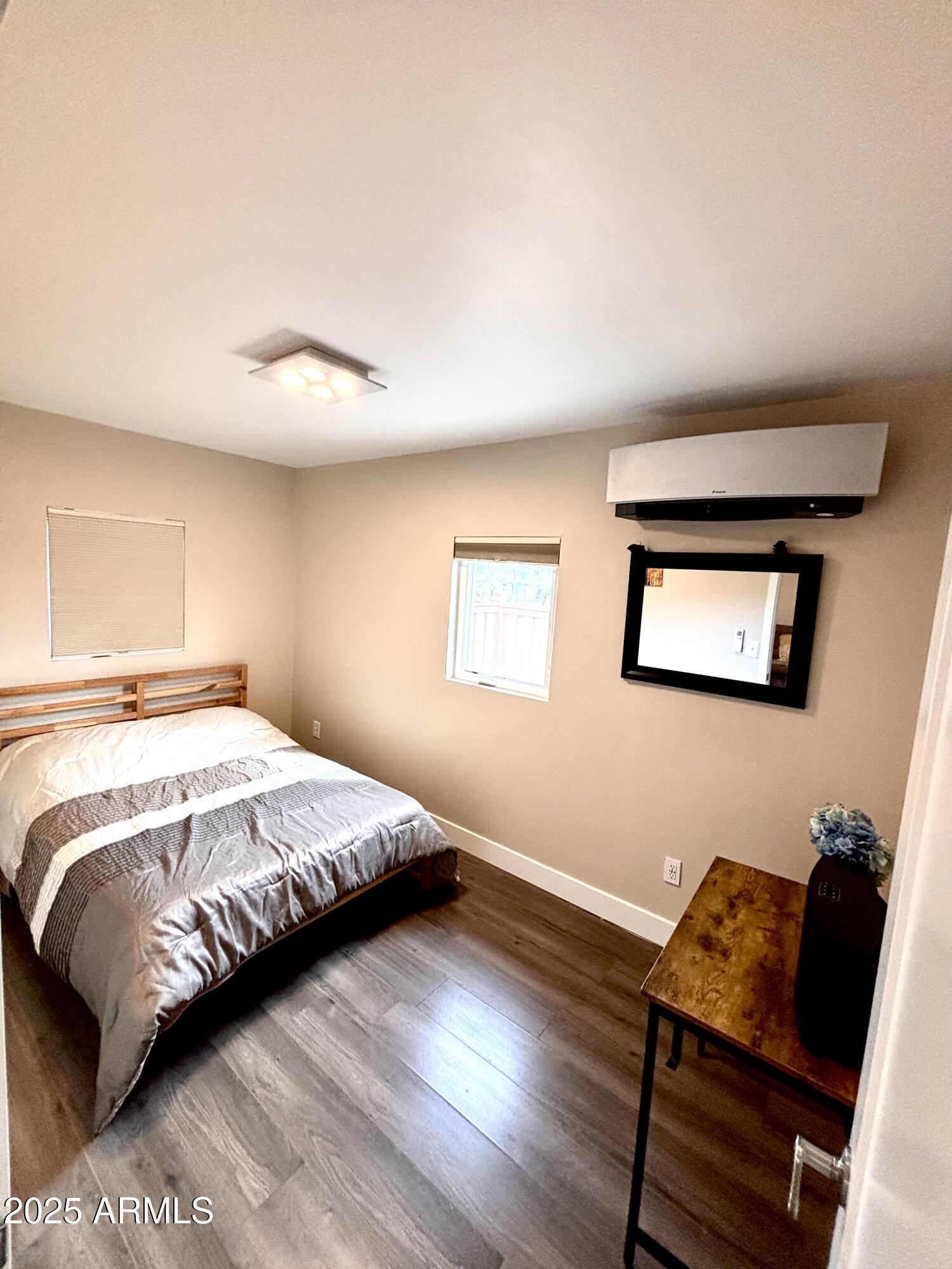 311 Solana Avenue Ajo, AZ 85321 - Photo 13 of 22 a bedroom with a bed and wooden floor