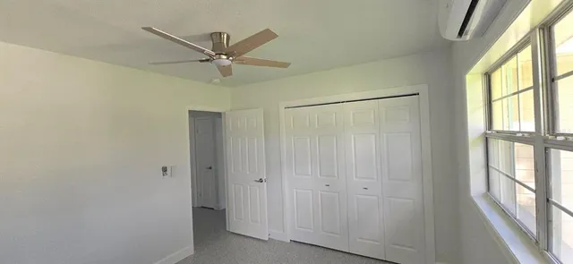 a bathroom with a granite countertop toilet a sink and a bathtub