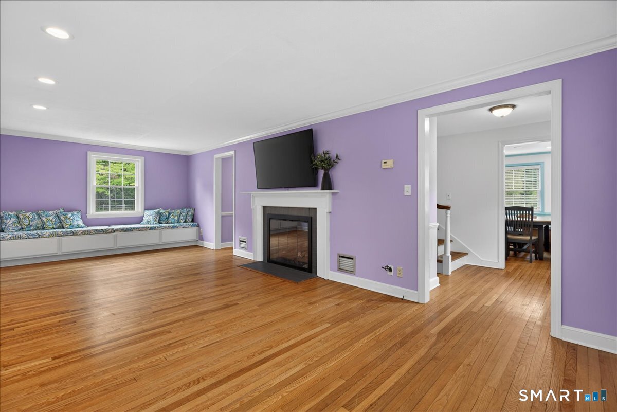 1006 King Road Cheshire, CT 06410 - Photo 9 of 40 The Living Room is outfitted with a gas log fireplace, hardwood floors, recessed lighting and a large TV that conveys with the house.