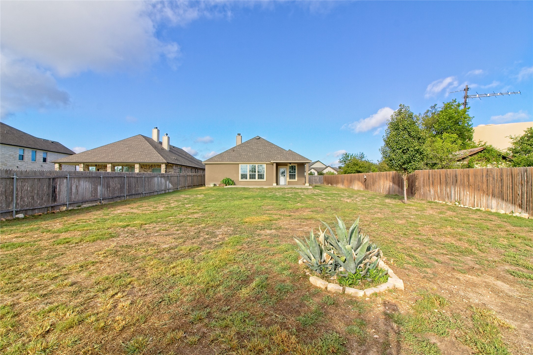 31443 Kingsway Road Georgetown, TX 78628 - Photo 23 of 40 A spacious yard with mature privacy fencing offers ample outdoor potential for recreation and relaxation.