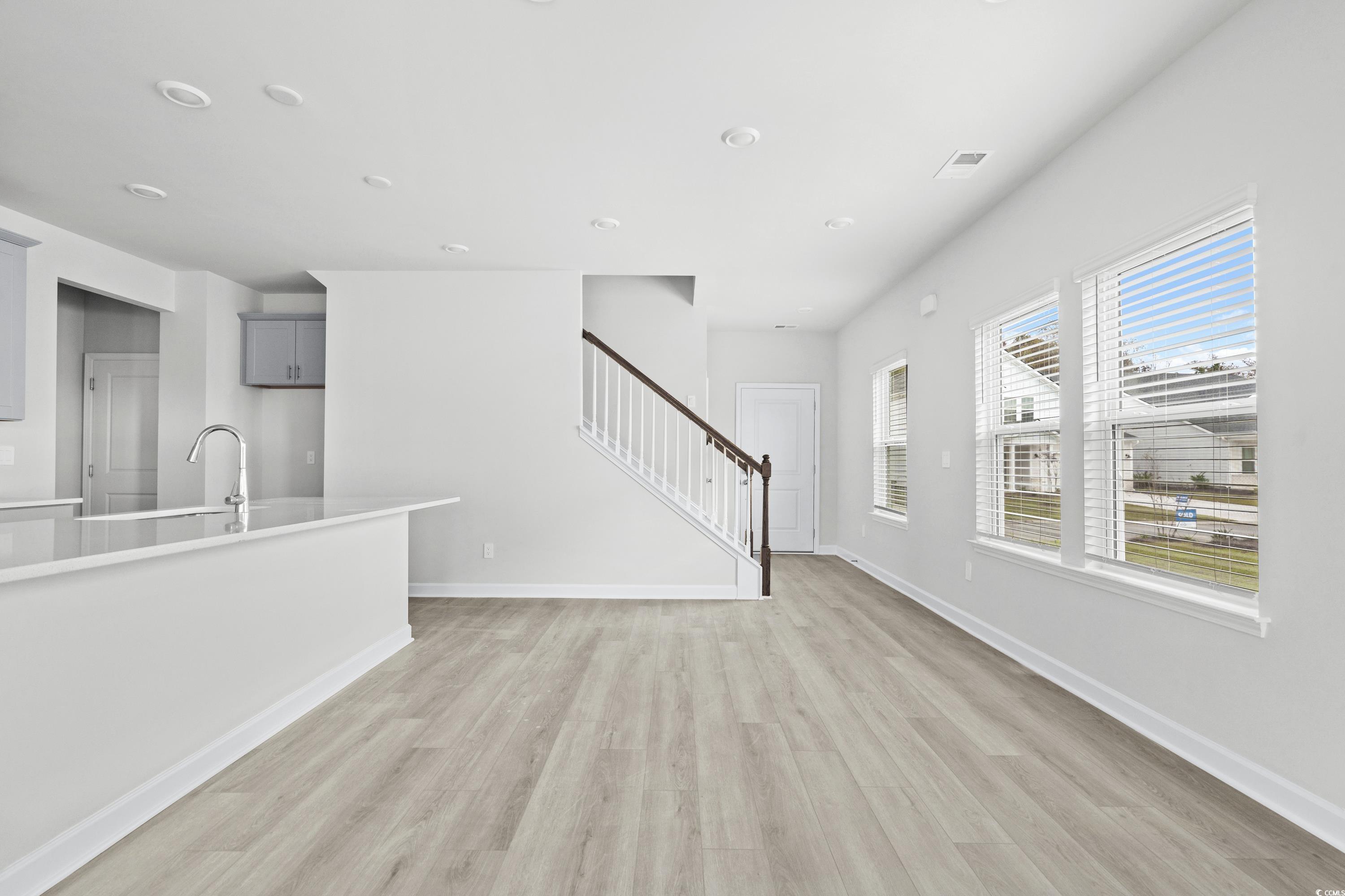 2113 Copper Crk Loop Longs, SC 29568 - Photo 8 of 37 Unfurnished living room featuring light hardwood /
