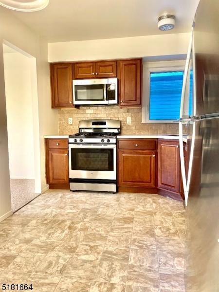 365 Patricia Court Union, NJ 07083 - Photo 5 of 14 a kitchen with stainless steel appliances granite countertop a stove a sink and a microwave