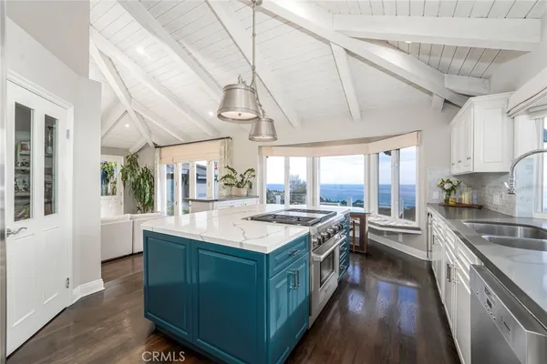 a kitchen with a stove and a white cabinets