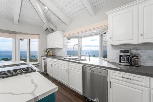 a kitchen with a sink and a large window