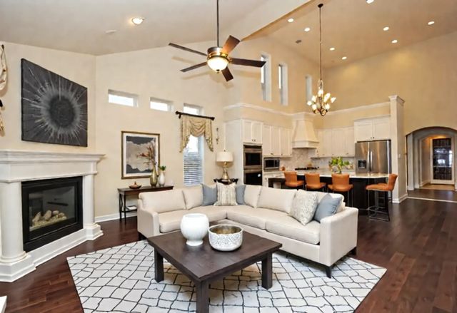 a living room with furniture kitchen view and a fireplace