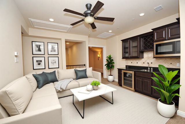 a living room with furniture a window and a potted plant
