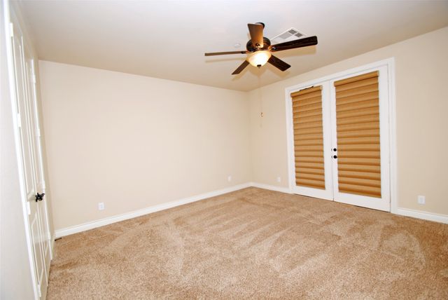 a view of a livingroom with a ceiling fan and wooden floor