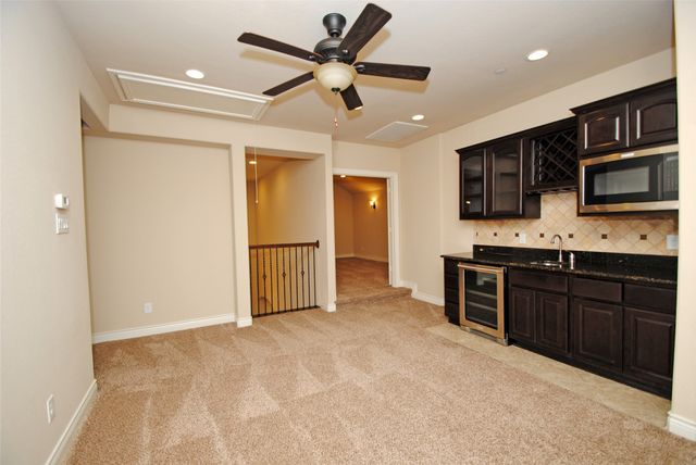 a kitchen with stainless steel appliances granite countertop a refrigerator stove and microwave