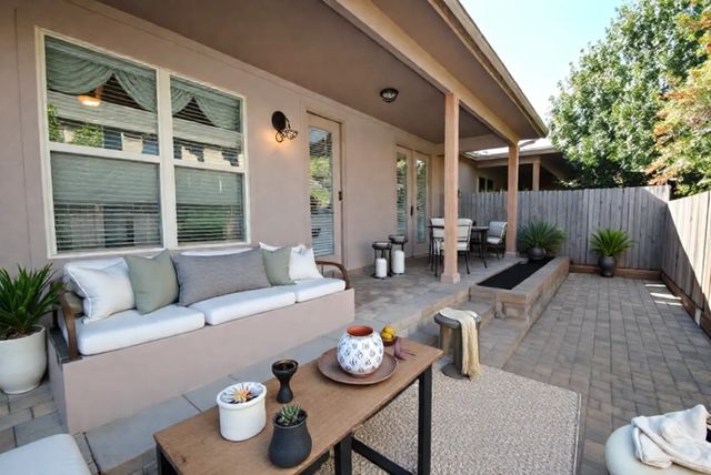 a outdoor space with patio the couches and a dining table with the potted plants
