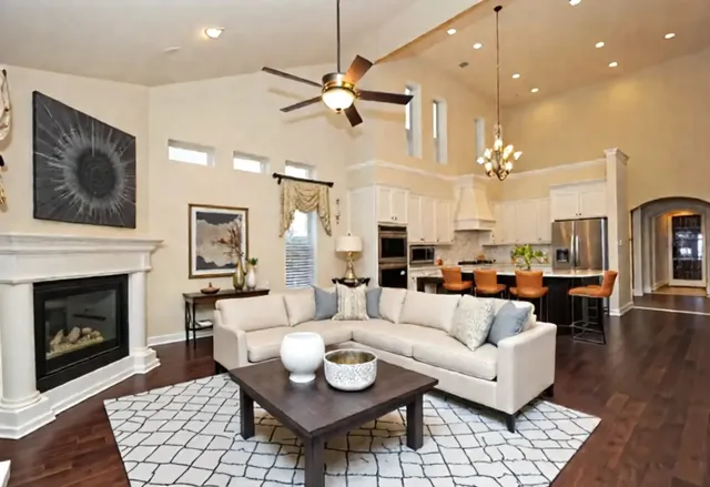 a living room with furniture kitchen view and a fireplace