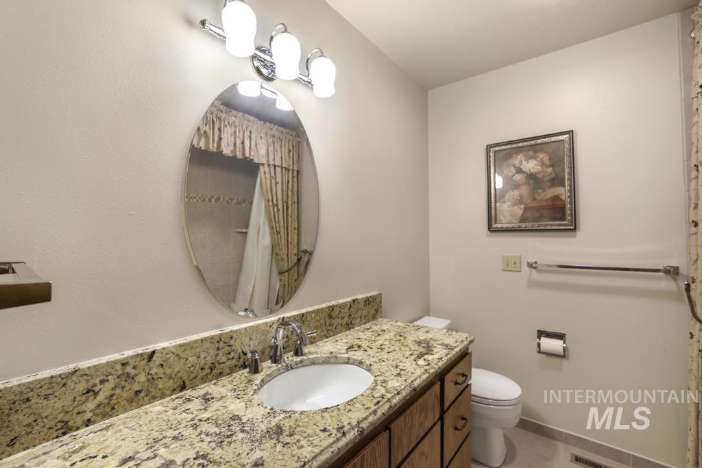 2018 Rancho Vista Drive Twin Falls, ID 83301 - Photo 31 of 50 Vanity with a stone countertop, an integrated sink, and chrome fixtures