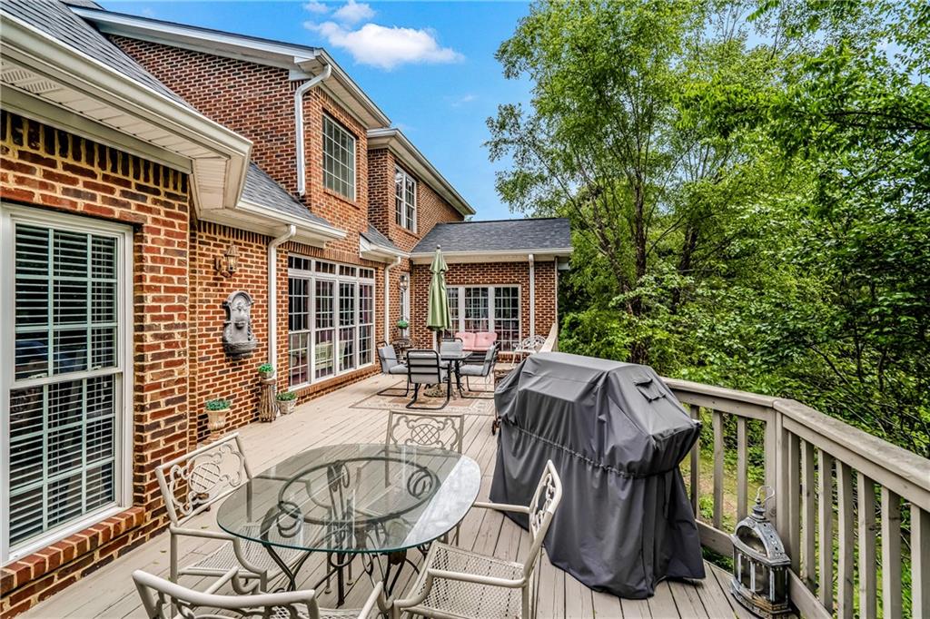 411 Overlook Way Cohutta, GA 30710 - Photo 27 of 86 a view of a patio with table and chairs with wooden deck and plants