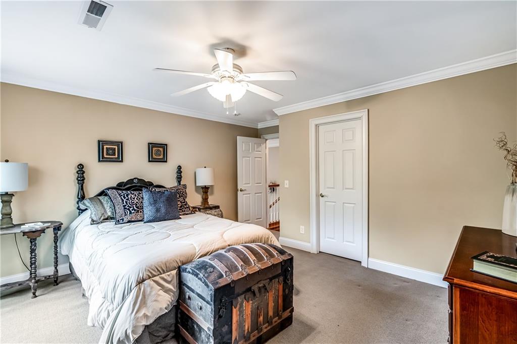 411 Overlook Way Cohutta, GA 30710 - Photo 60 of 86 a spacious bedroom with a bed and a chandelier