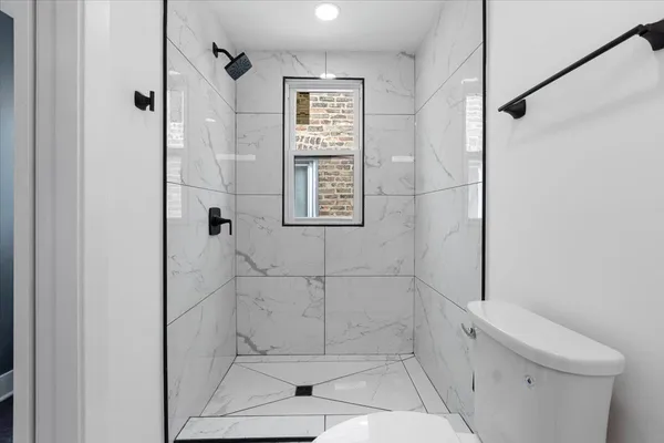 a bathroom with a shower and toilet