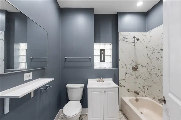 a bathroom with a sink toilet and shower