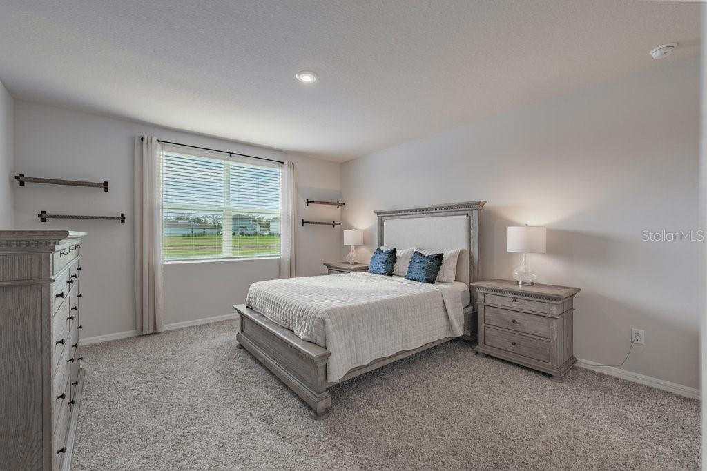 7041 Feather River Place Parrish, FL 34219 - Photo 14 of 32 a bed room with a bed and a window