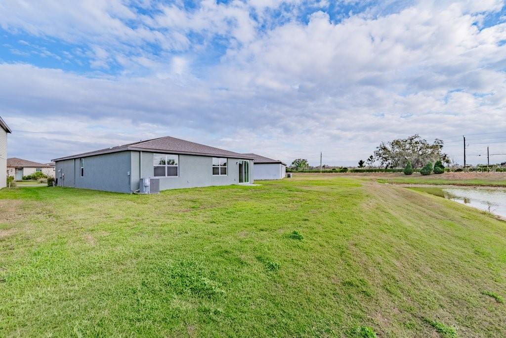 7041 Feather River Place Parrish, FL 34219 - Photo 27 of 32 a front view of house with yard and big trees