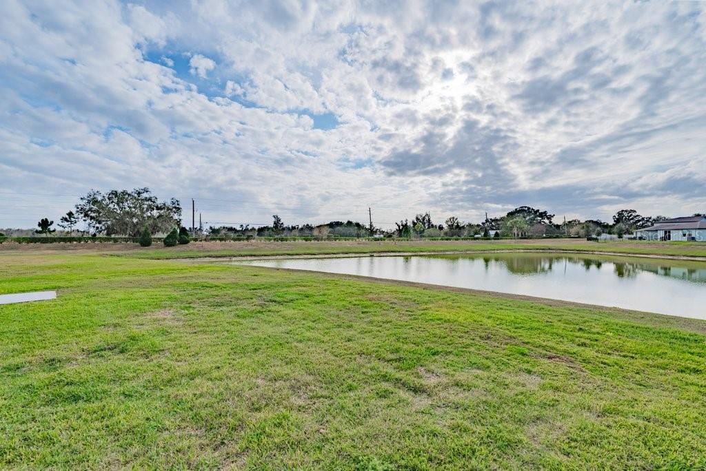 7041 Feather River Place Parrish, FL 34219 - Photo 28 of 32 a view of a lake with houses in the background