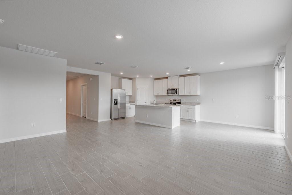 7041 Feather River Place Parrish, FL 34219 - Photo 5 of 32 a view of kitchen cabinet and refrigerator