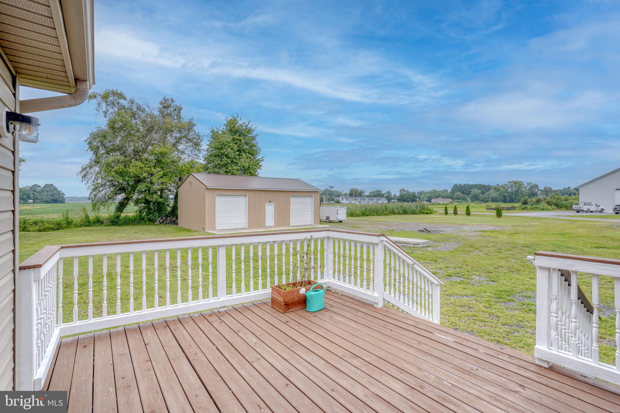 5926 Mt Holly Road East New Market, MD 21631 - Photo 12 of 36 a view of a deck with wooden floor and fence next to a yard