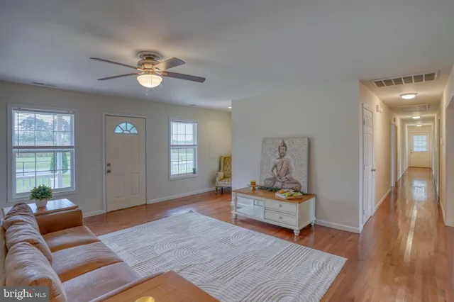 a view of an empty room and wooden floor