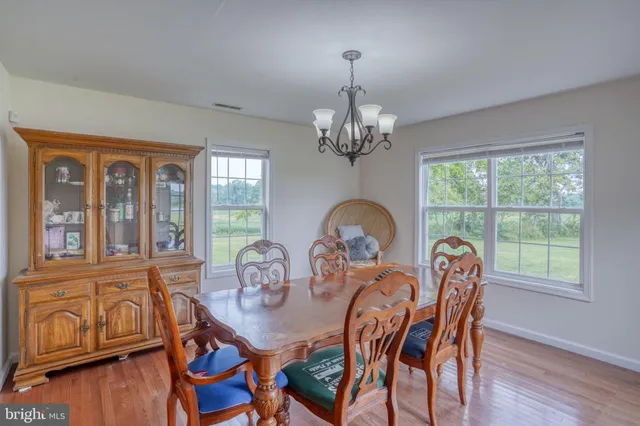 a view of a dining room with furniture and chandelier