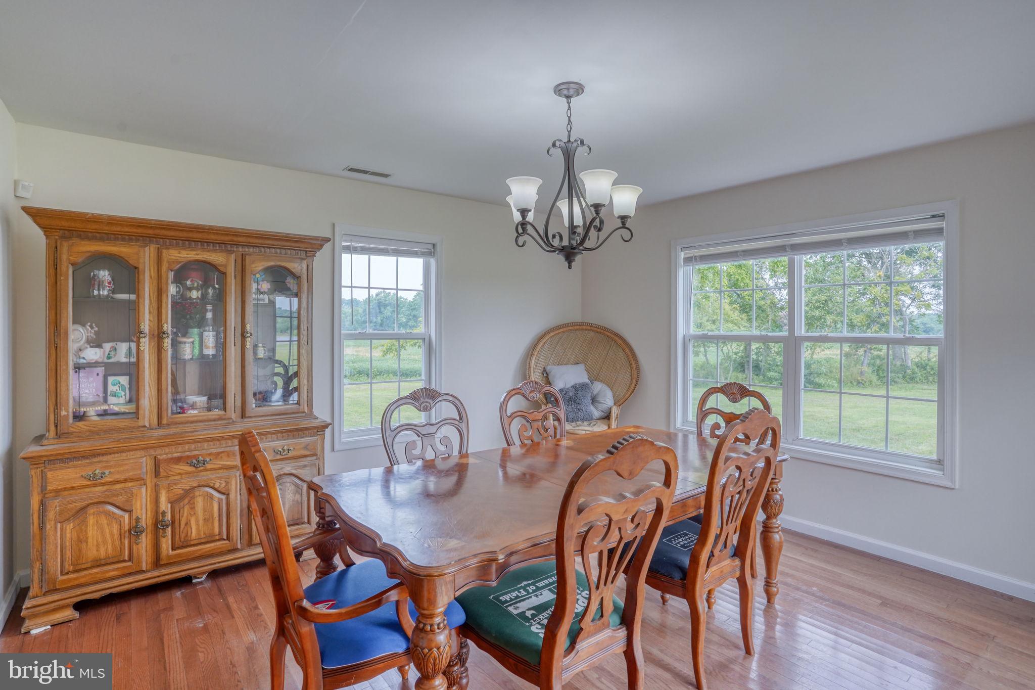 5926 Mt Holly Road East New Market, MD 21631 - Photo 24 of 36 a view of a dining room with furniture window and wooden floor