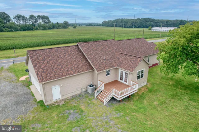 an aerial view of a house with a yard and lake view