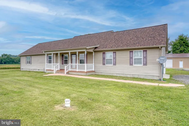 a house view with swimming pool in front of it