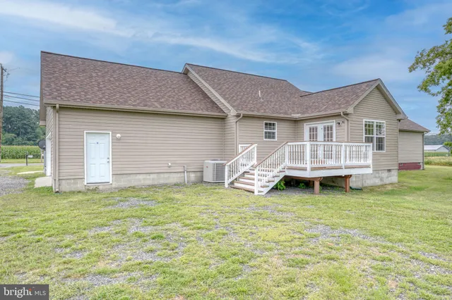 a view of a house with a yard and deck
