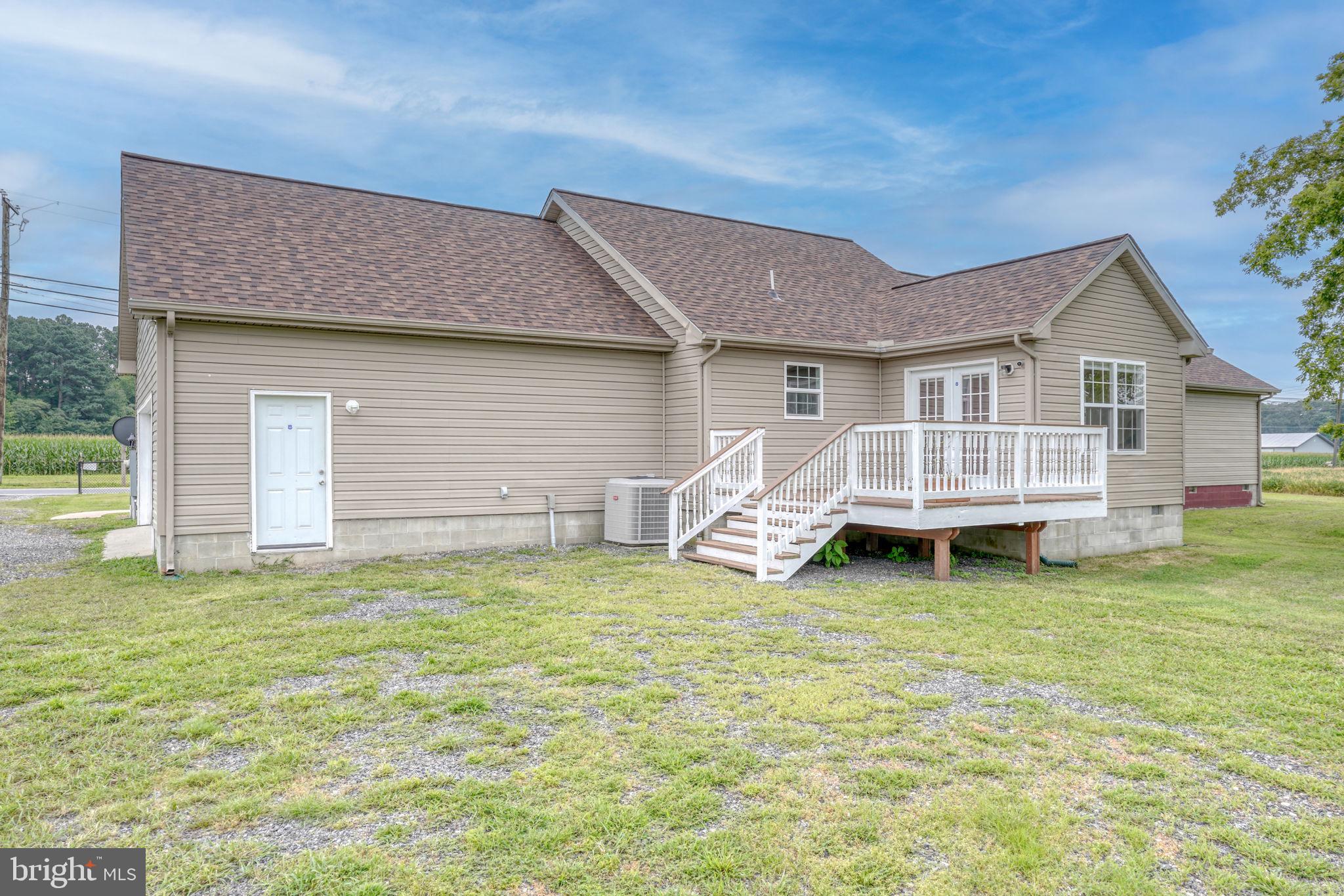 5926 Mt Holly Road East New Market, MD 21631 - Photo 10 of 36 a view of a house with a yard and deck