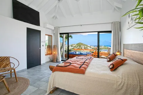 a bedroom with a bed and glass windows