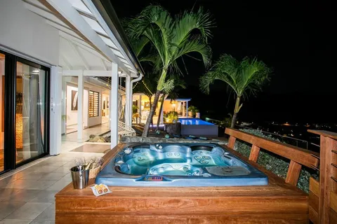 a view of a chairs and table in patio with swimming pool