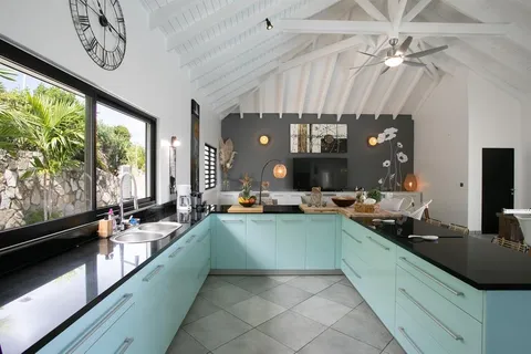 a large kitchen with a large window and stainless steel appliances