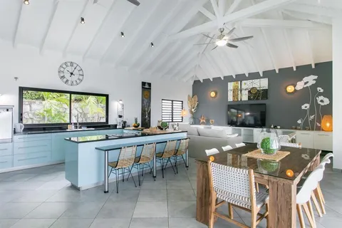 a large kitchen with a table and chairs