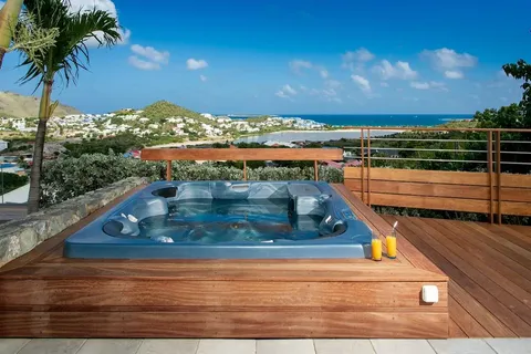 a view of a house with swimming pool and sitting area