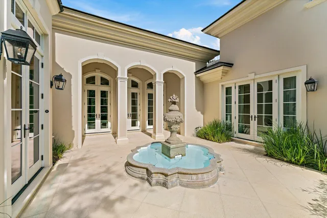 a view of a house with backyard and glass windows
