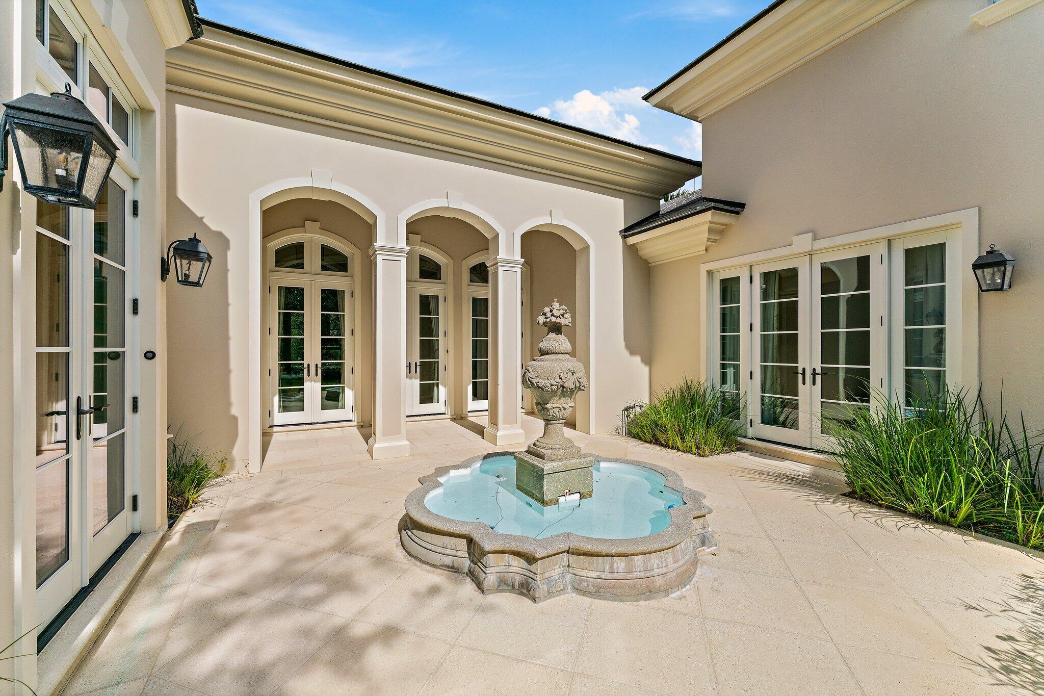124 Bears Club Drive Jupiter, FL 33477 - Photo 14 of 22 a view of a house with backyard and glass windows